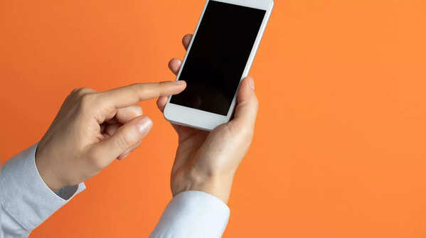 Person holding phone in one hand, scrolling with the index finger of the other.