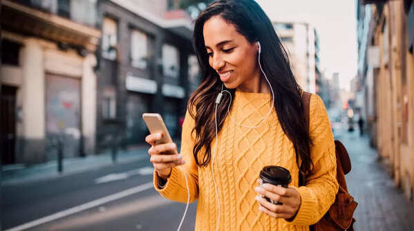 Person holding phone in one hand, scrolling with the thumb.