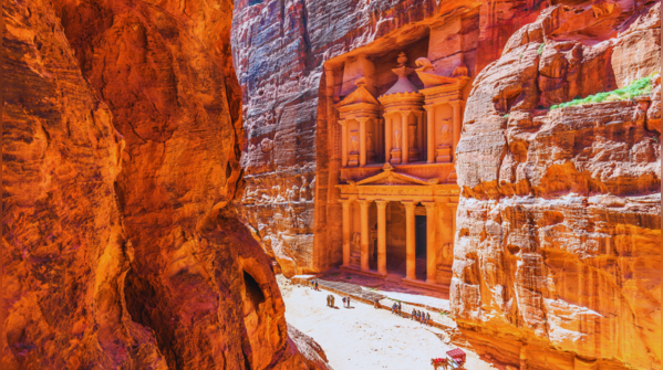 The stunning facade of The Treasury in Petra, Jordan, carved into sandstone cliffs.