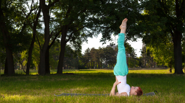 Performing Sarvangasana under guidance for thyroid stimulation
